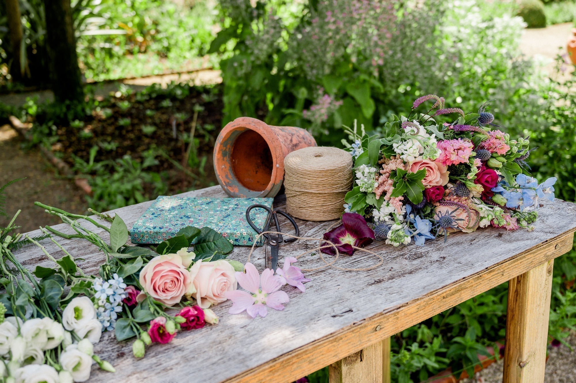 Flower Subscription stems on a table with florist scissors