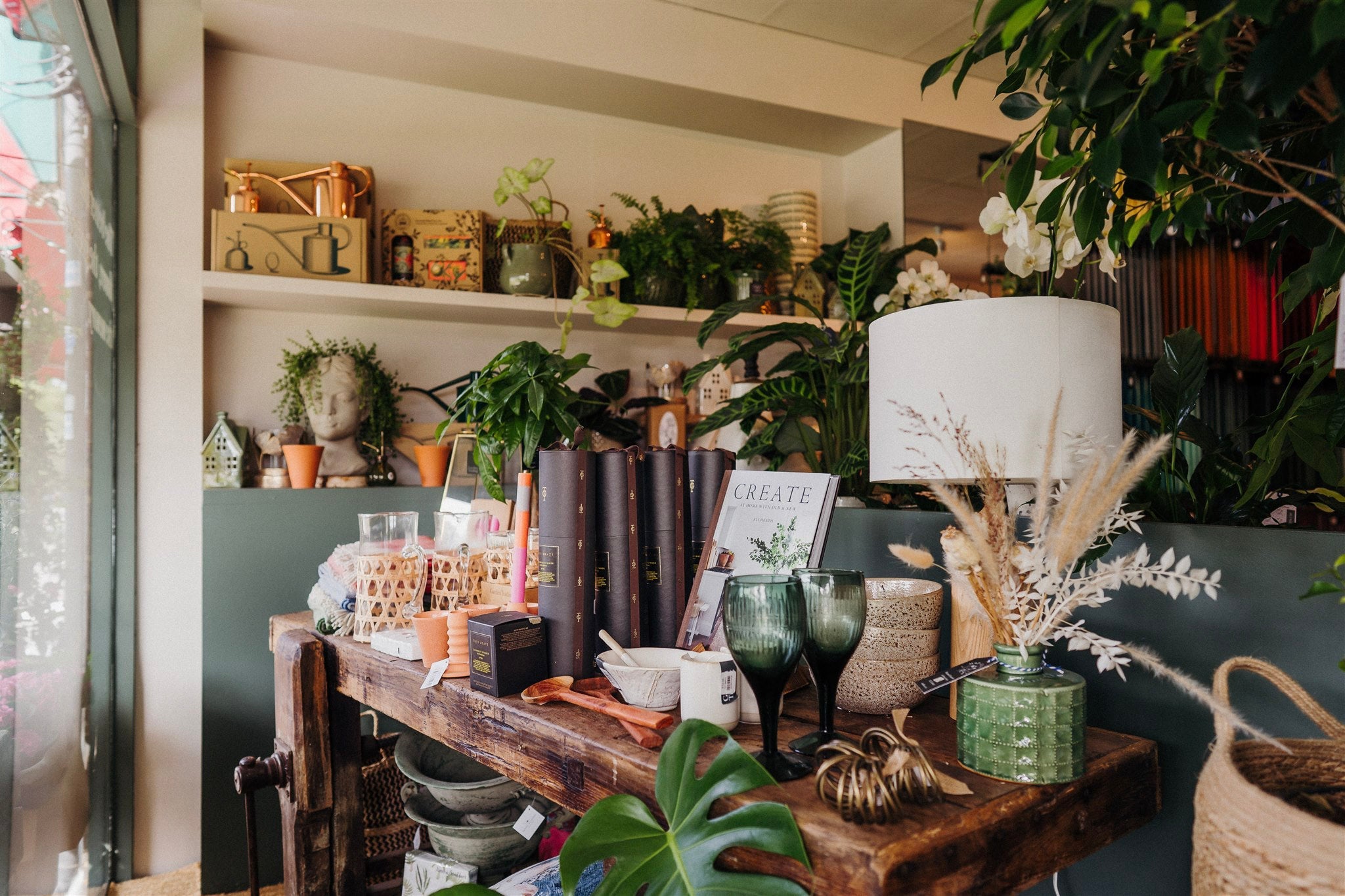 Mad Lilies shop window display with homeware and gifts on a wooden table