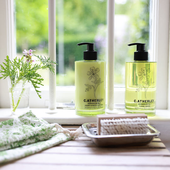C. Atherley geranium-infused hand and body lotion styled in a bathroom