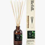 Luxury reed diffuser refill styled with reeds and home decor warm amber fragrance