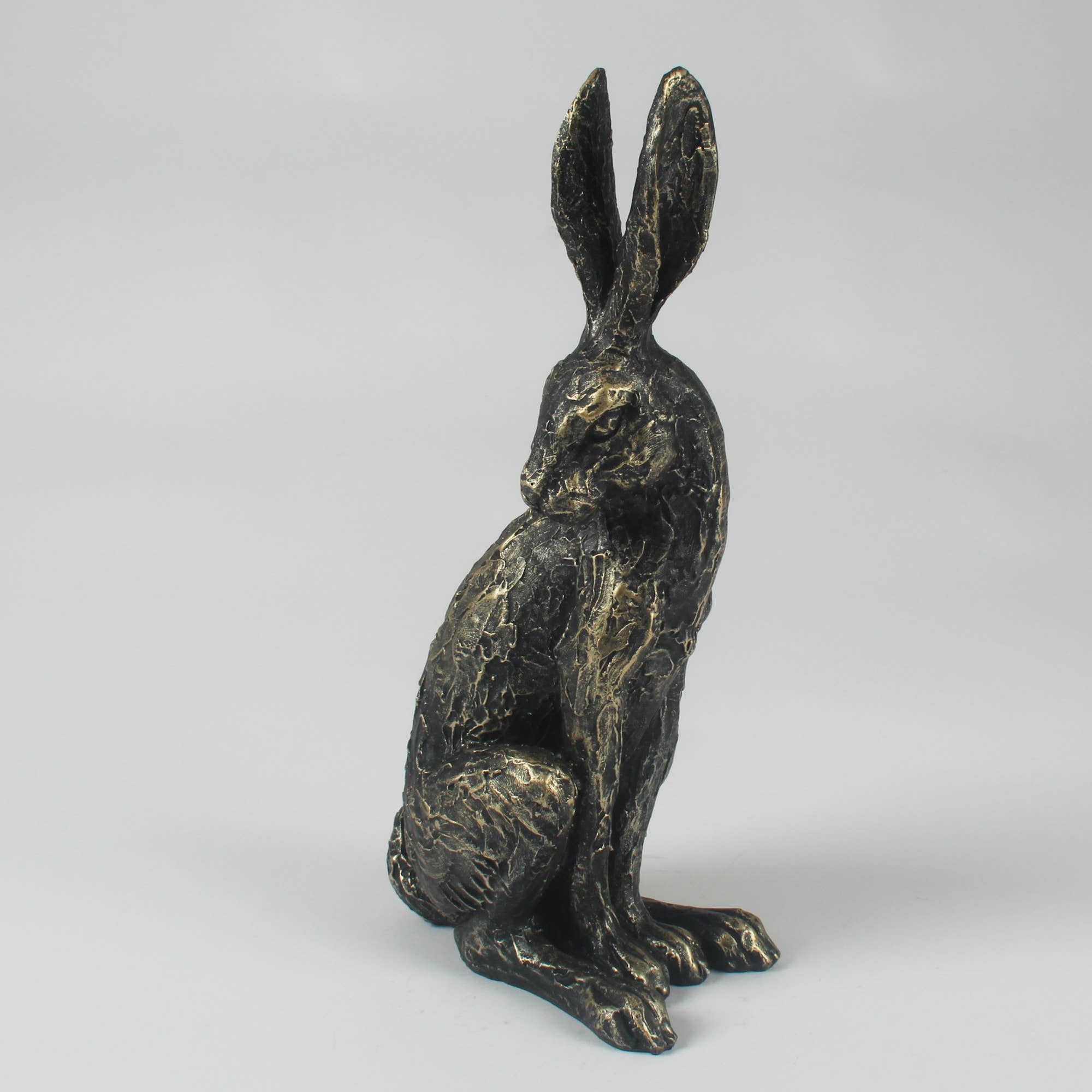 Antique bronze sitting hare ornament with detailed fur texture, decorative resin woodland sculpture for country and contemporary interiors.