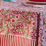 Pink floral block print cotton tablecloth with red and white candy stripe border styled for elegant dining and entertaining.