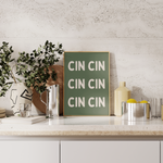 Elegant cream and olive green typography wall art featuring the phrase ‘Cin Cin’. Perfect for kitchens, dining rooms, home bars and gallery walls.