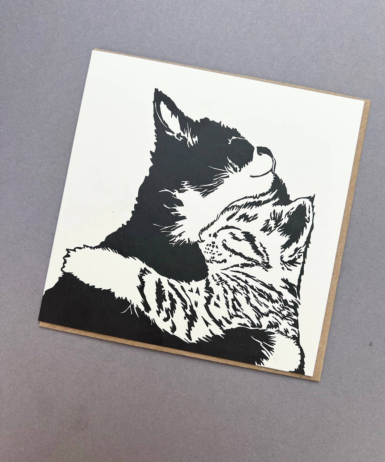 Penguin Ink Cuddle Time letterpress greeting card featuring two cuddling kittens, printed on 100% recycled board with a tactile embossed finish.