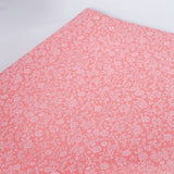 Pink tissue paper with a subtle pattern on a white background