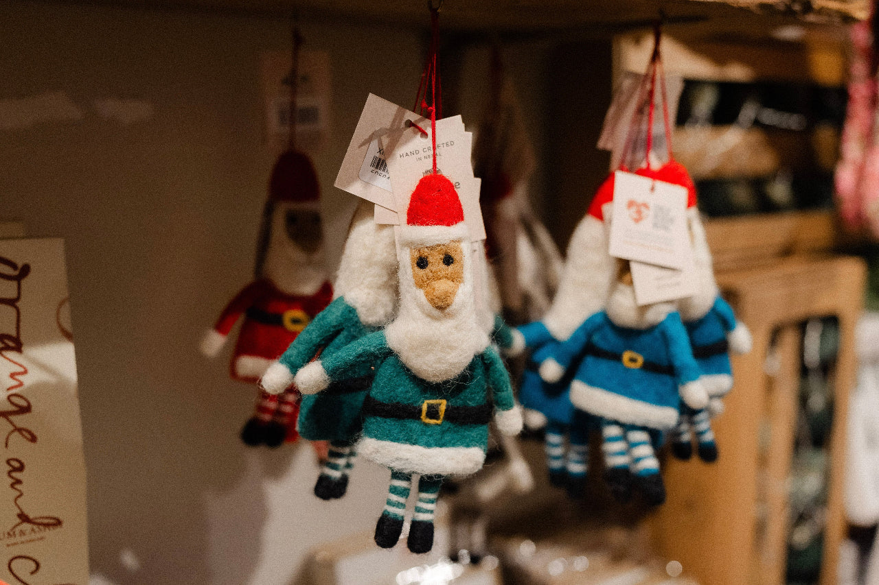 Decorative gnome ornaments hanging on a shelf with a blurred background