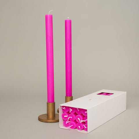Brighten your home with the True Grace Flourescent Purple Candle. A luxury purple taper candle with a 12-hour burn time, perfect for elegant table styling.