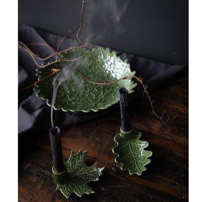 A green leaf-shaped charger 