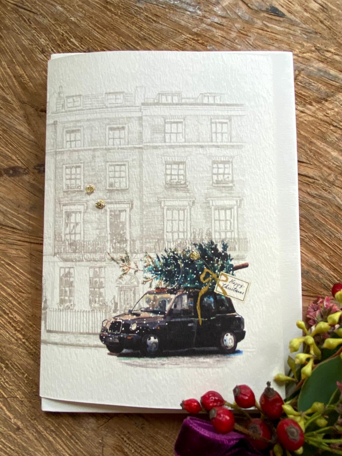 Handmade Black Cab Christmas Tree card featuring original artwork by Elena Deshmukh, individually hand stitched on premium textured cardstock.
