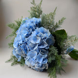 omething Blue Hydrangeas – luxury blue hydrangea stems with large cloud-like blooms arranged in a vase.