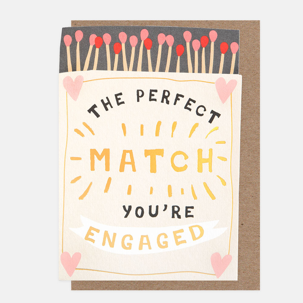 The Perfect Match engagement card featuring a die-cut matchbox with pink and red matches and gold foil detailing.