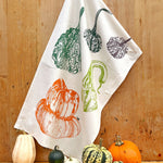 Tea towel with autumnal design of pumpkins and gourds 
