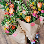 Seasonal flower gift wrap featuring a hand-selected mix of fresh flowers wrapped in kraft paper and ribbon.