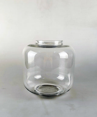 Mad Lilies Signature Glass Belly Vase, a 20cm clear glass vase perfectly shaped for hand-tied bouquets and fresh seasonal flowers.