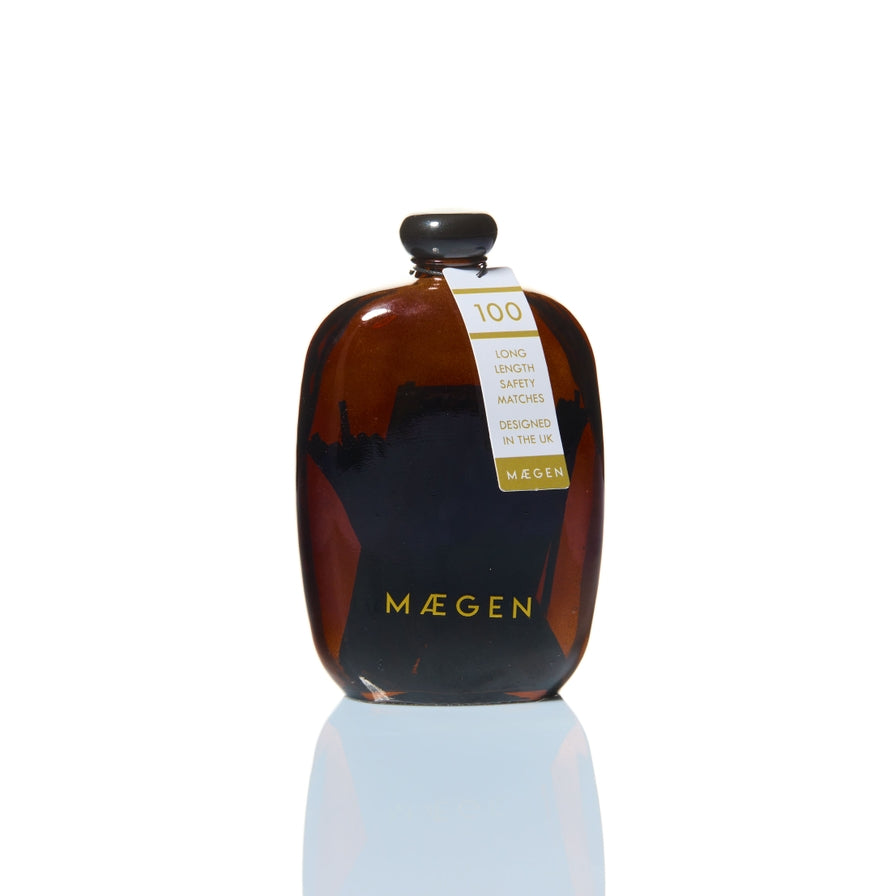 Black matches in glass bottle