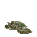Green ceramic leaf-shaped dishes on a white background