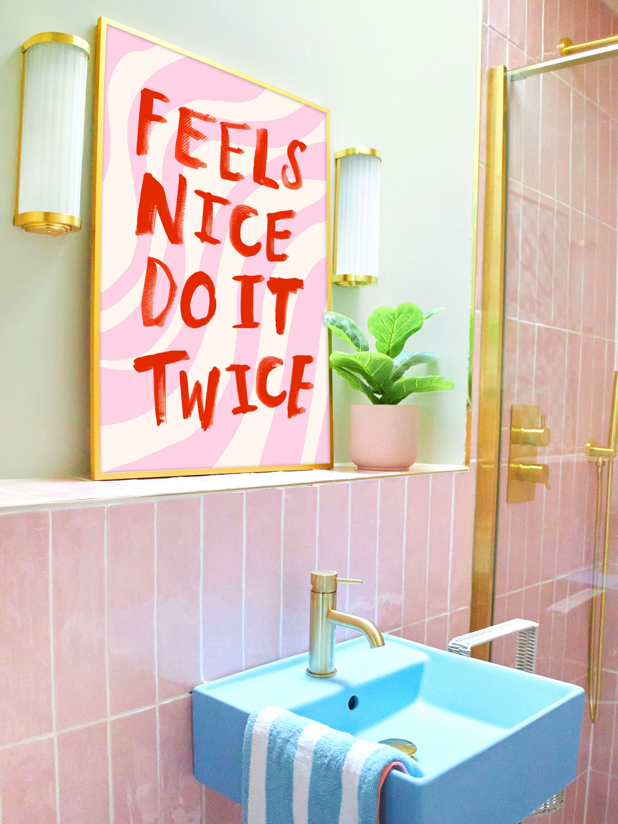 Bathroom with pink tiles, blue sink, and motivational poster.