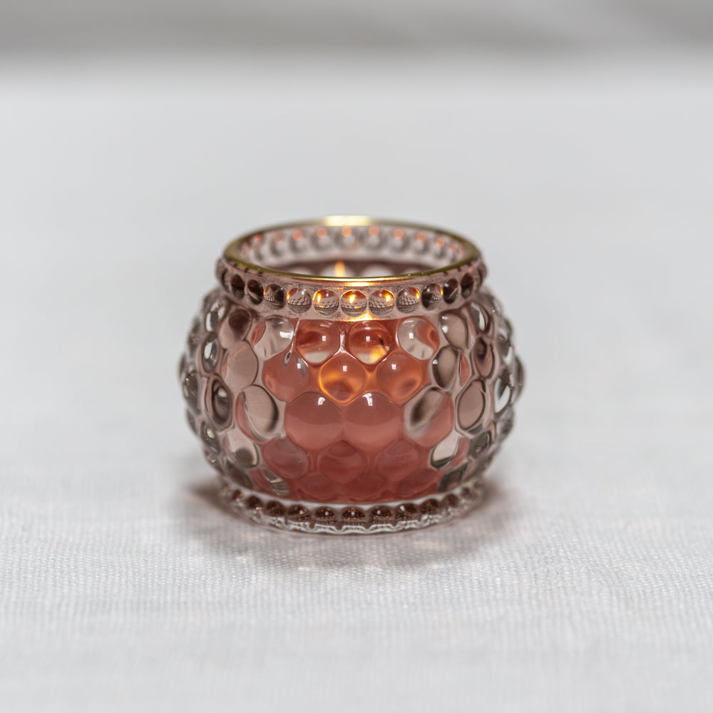 Rose gold candle holder on a white background