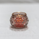 Rose gold candle holder on a white background