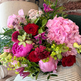 The Cherry Bomb Peony Bouquet featuring pink peonies and vibrant seasonal flowers in rich pink and cherry red tones