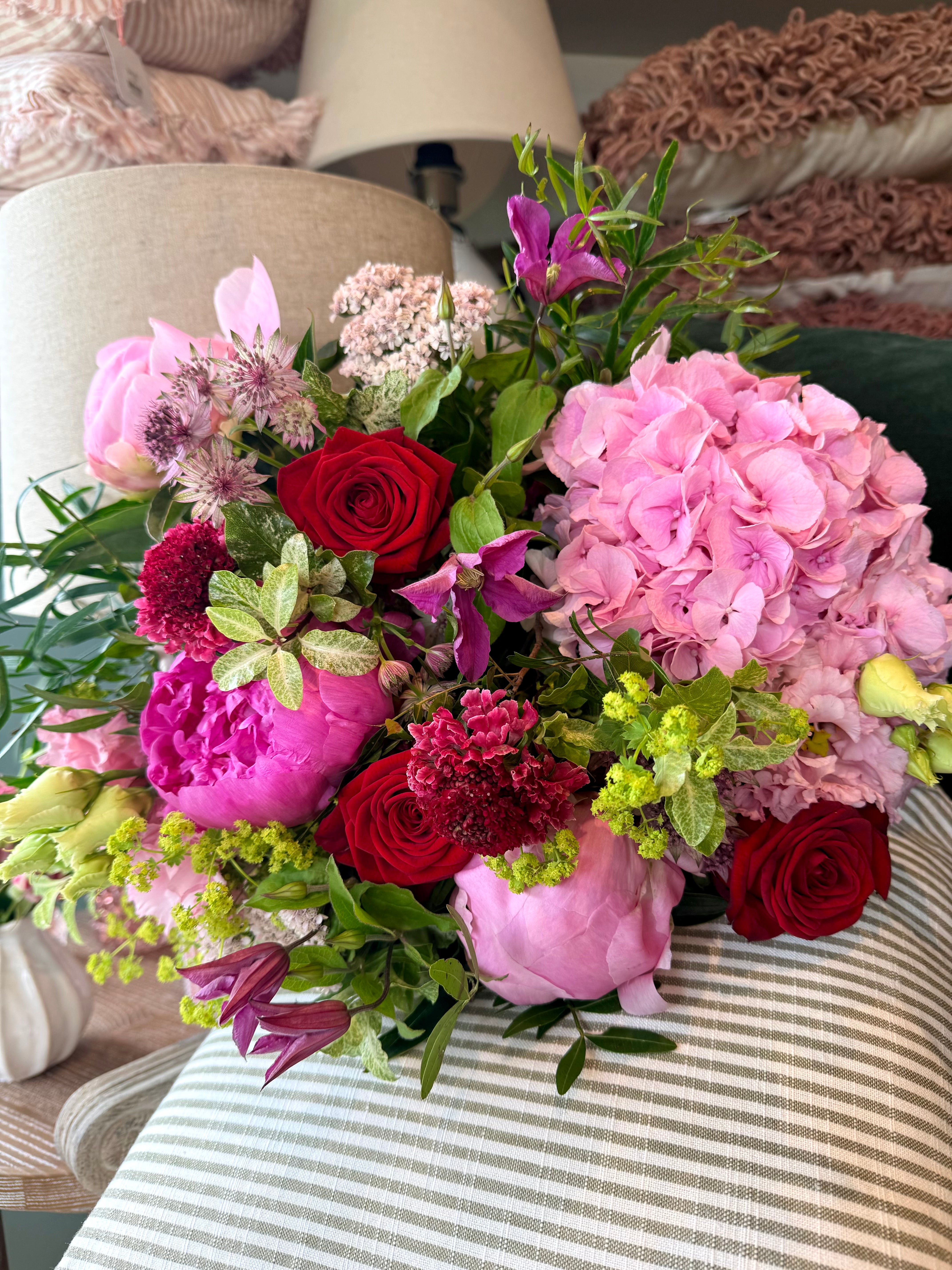 The Cherry Bomb Peony Bouquet featuring pink peonies and vibrant seasonal flowers in rich pink and cherry red tones