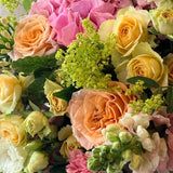 July Bouquet of the Month featuring pink hydrangeas, apricot roses, yellow Bandolero roses, snapdragons and seasonal summer flowers.