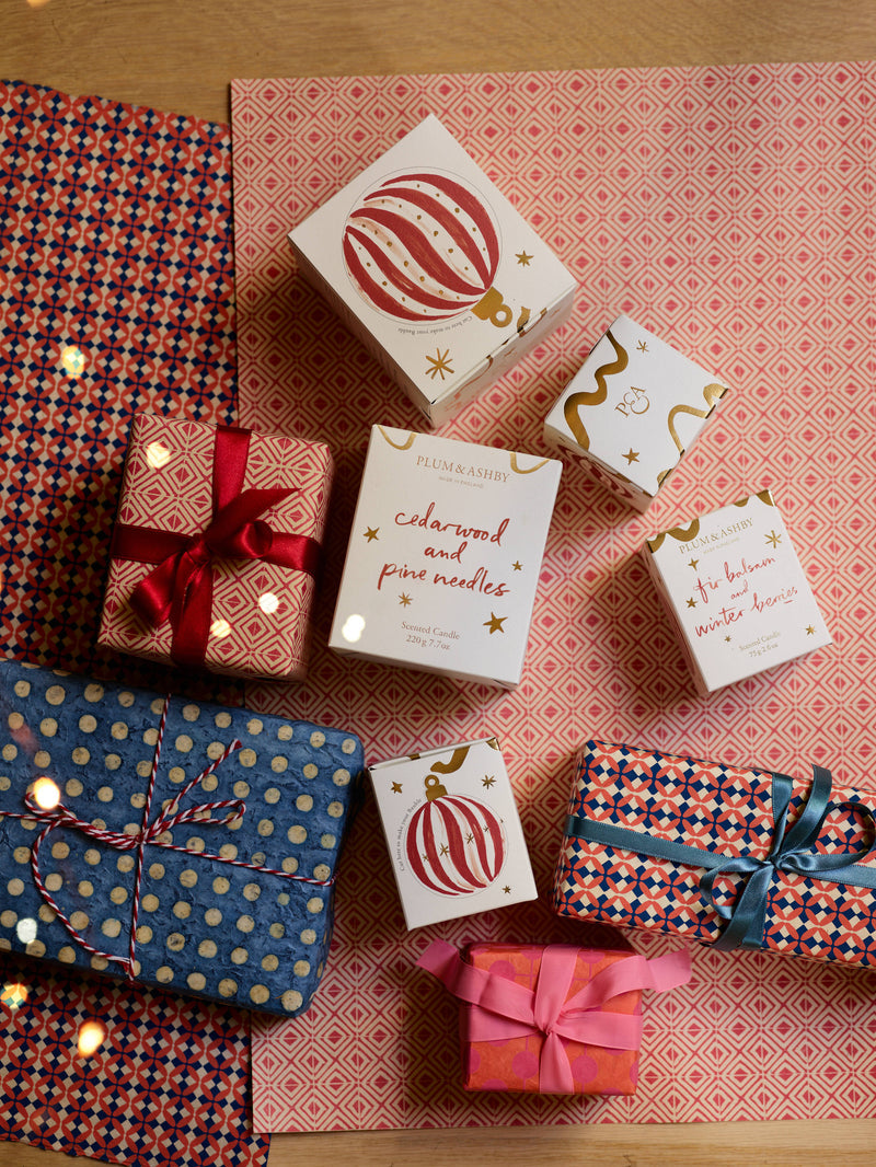 festive pine candle presented in a beautifully illustrated box