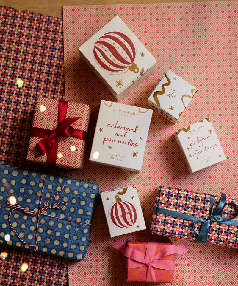 festive pine candle presented in a beautifully illustrated box