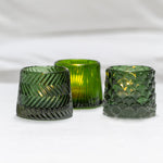 Green glass tealight holders with a geometric pattern