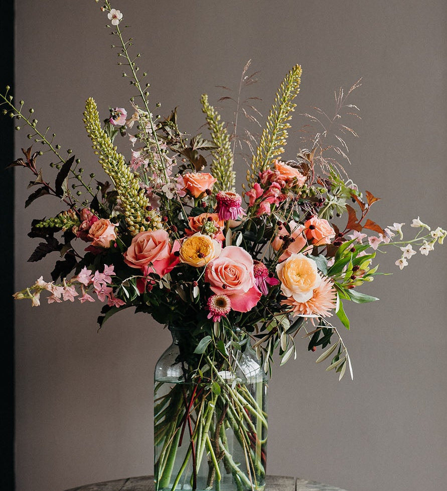 Statement summer vase arrangement with summmer flowers and textured foliage designed for maximum impact.