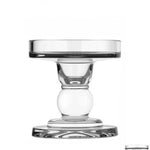 A clear glass candle holder with a sleek design