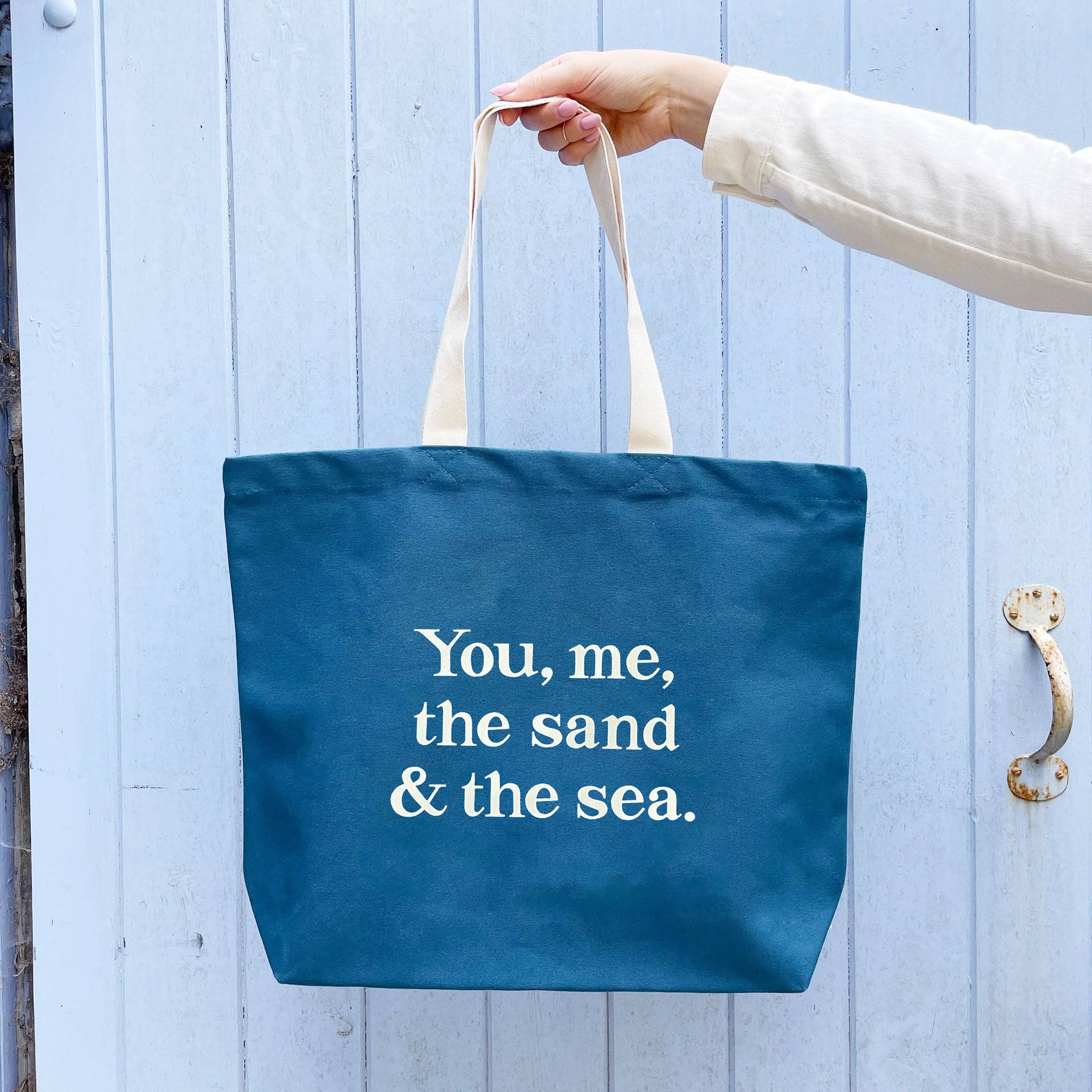 Alphabet Bags You, Me, the Sand &amp; the Sea ocean blue cotton canvas tote bag with off-white coastal design, made in the UK.