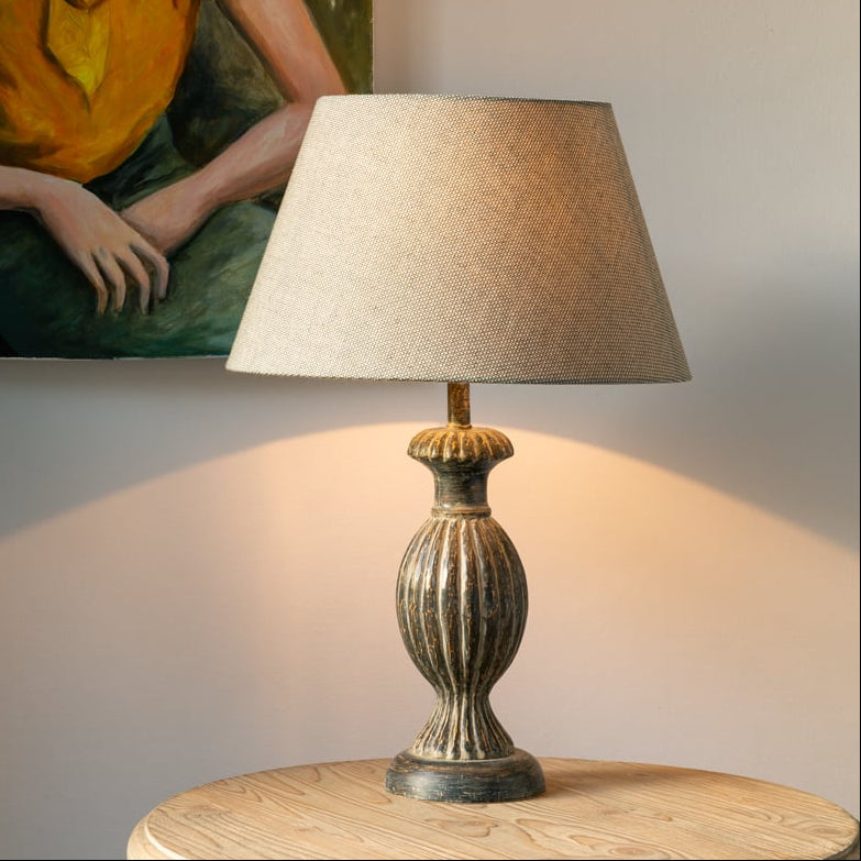 Elegant stonewash grey table lamp with a ribbed ceramic finish and neutral shade. Perfect for bedrooms, living rooms and soft contemporary interiors.