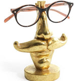 Quirky antique gold moustache glasses holder. A decorative and practical stand for spectacles or sunglasses. Perfect for desks or bedside tables.