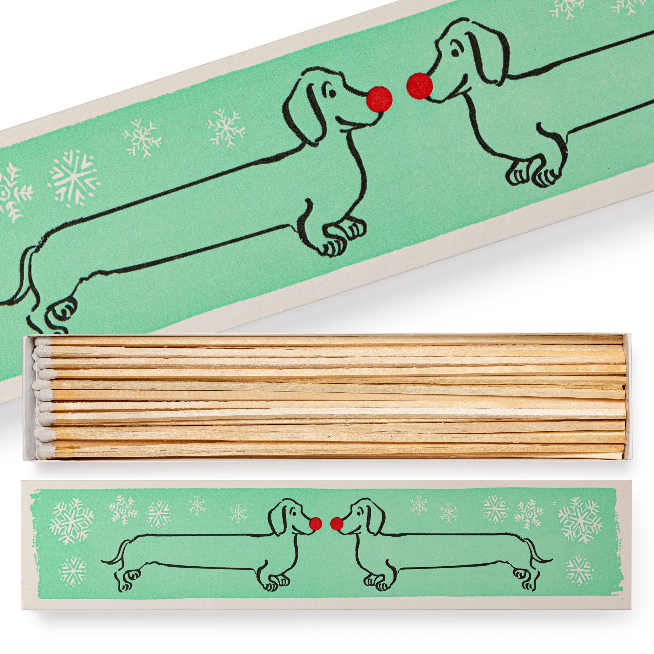 Shop the Archivist Dachshund in the Snow luxury long matchbox. A festive dog design perfect for candles, fireplaces, gifting and Christmas stockings.