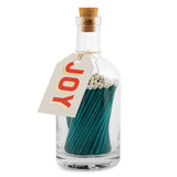 Archivist green extra-long safety matches with white tips in a reusable glass bottle with cork stopper and integrated strike plate.