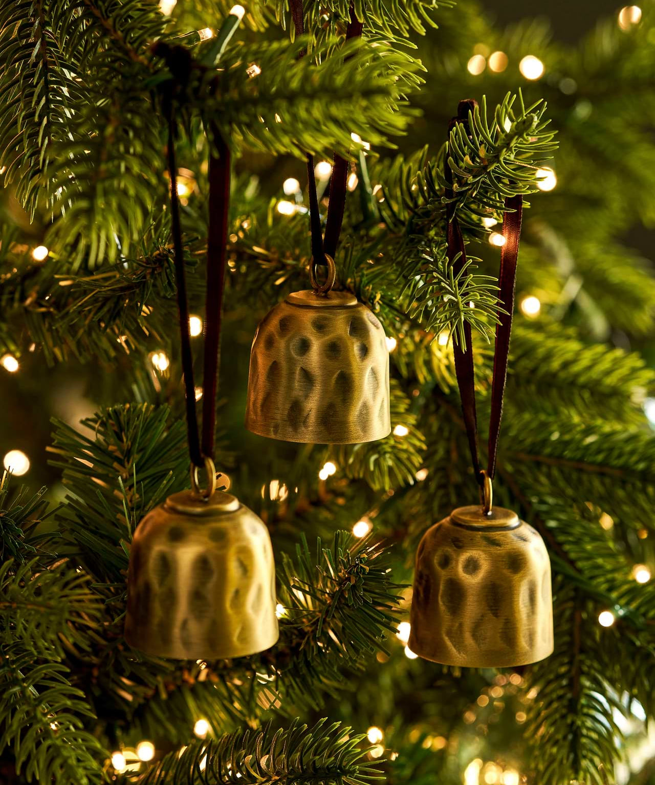 Shop the Ardington Set of 3 Hanging Christmas Bells, crafted from hand-hammered steel with an antique brass finish and natural jute rope for festive styling.
