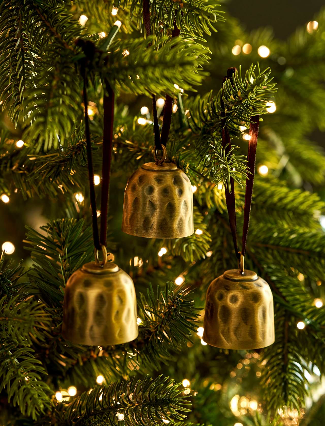Shop the Ardington Set of 3 Hanging Christmas Bells, crafted from hand-hammered steel with an antique brass finish and natural jute rope for festive styling.