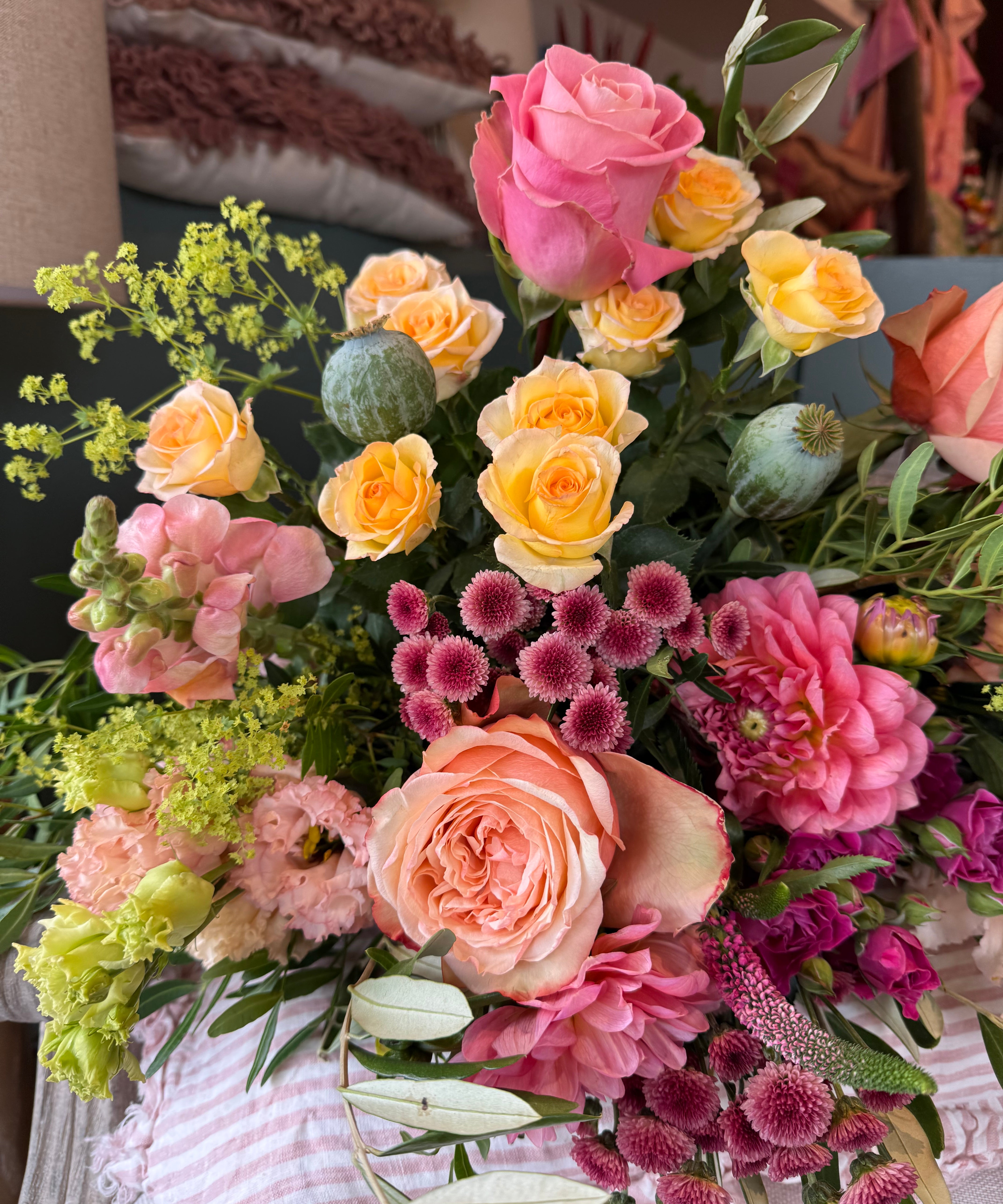 Luxury August Bouquet of the Month featuring seasonal dahlias, Bandolero tea roses, Peach Shimmer roses, apricot lisianthus, snapdragons and olive foliage in buttery yellow, apricot and dusky pink tones.