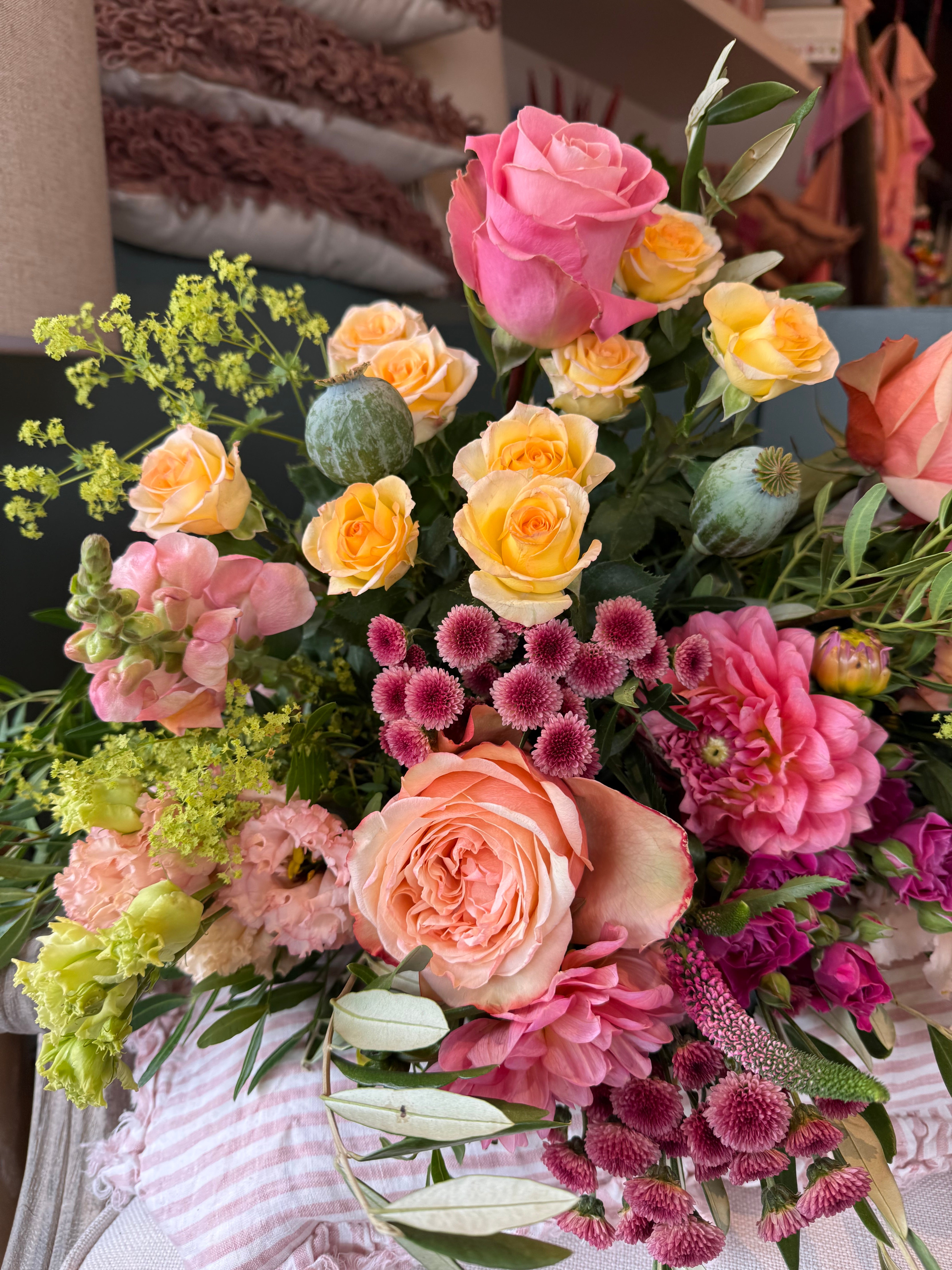 Luxury August Bouquet of the Month featuring seasonal dahlias, Bandolero tea roses, Peach Shimmer roses, apricot lisianthus, snapdragons and olive foliage in buttery yellow, apricot and dusky pink tones.