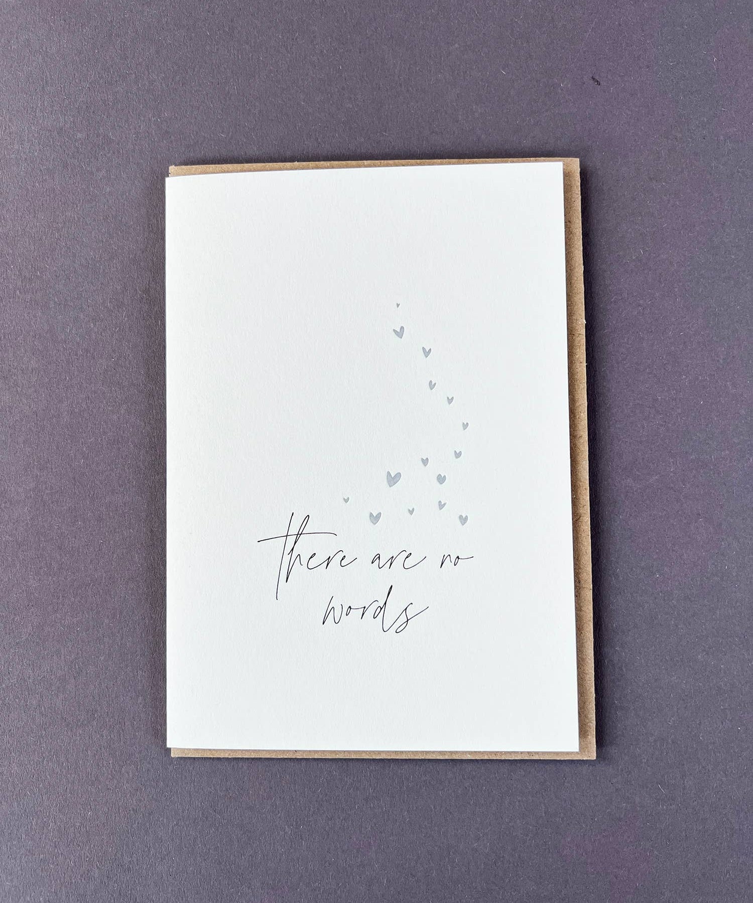 Penguin Ink There Are No Words letterpress sympathy card featuring metallic silver hearts and modern calligraphy, printed on 100% recycled board with a tactile embossed finish.