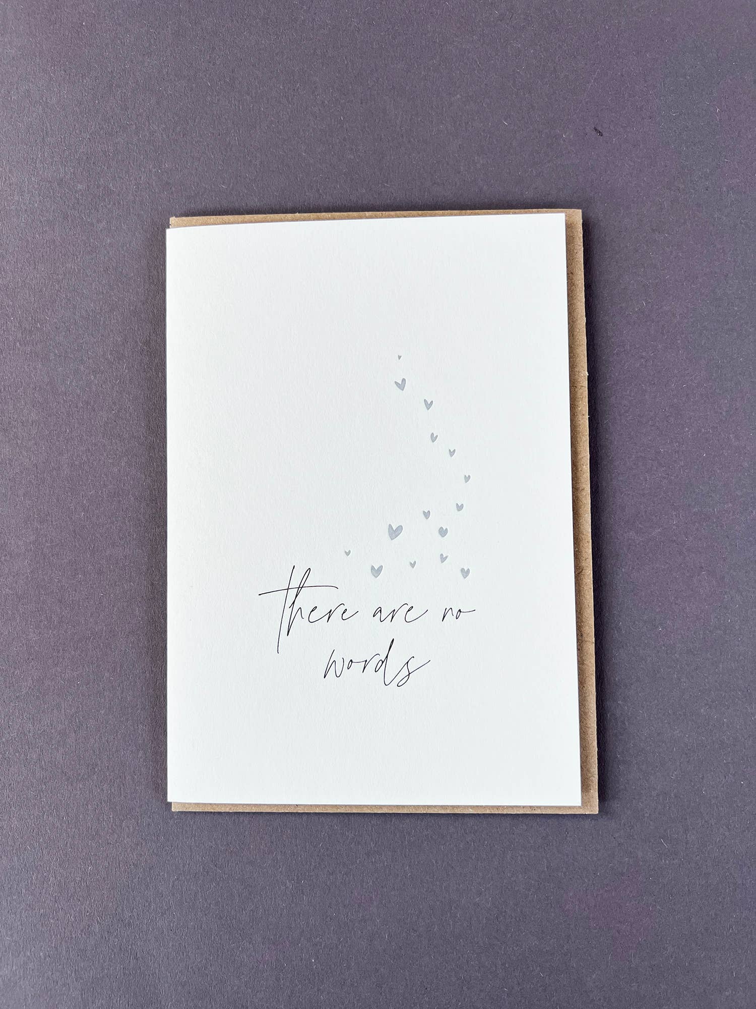 Penguin Ink There Are No Words letterpress sympathy card featuring metallic silver hearts and modern calligraphy, printed on 100% recycled board with a tactile embossed finish.