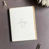 Penguin Ink Hugs letterpress mini thinking of you card with modern calligraphy, printed on 100% recycled board with a tactile embossed finish and C7 envelope.