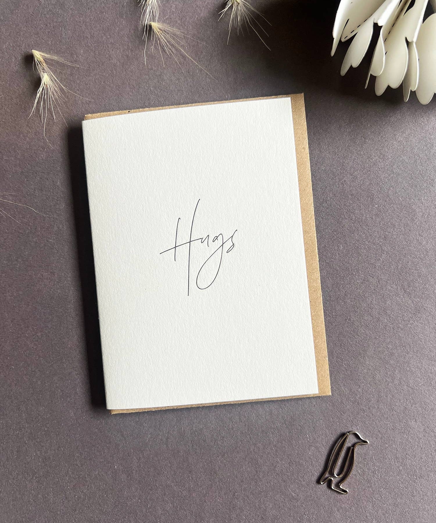 Penguin Ink Hugs letterpress mini thinking of you card with modern calligraphy, printed on 100% recycled board with a tactile embossed finish and C7 envelope.