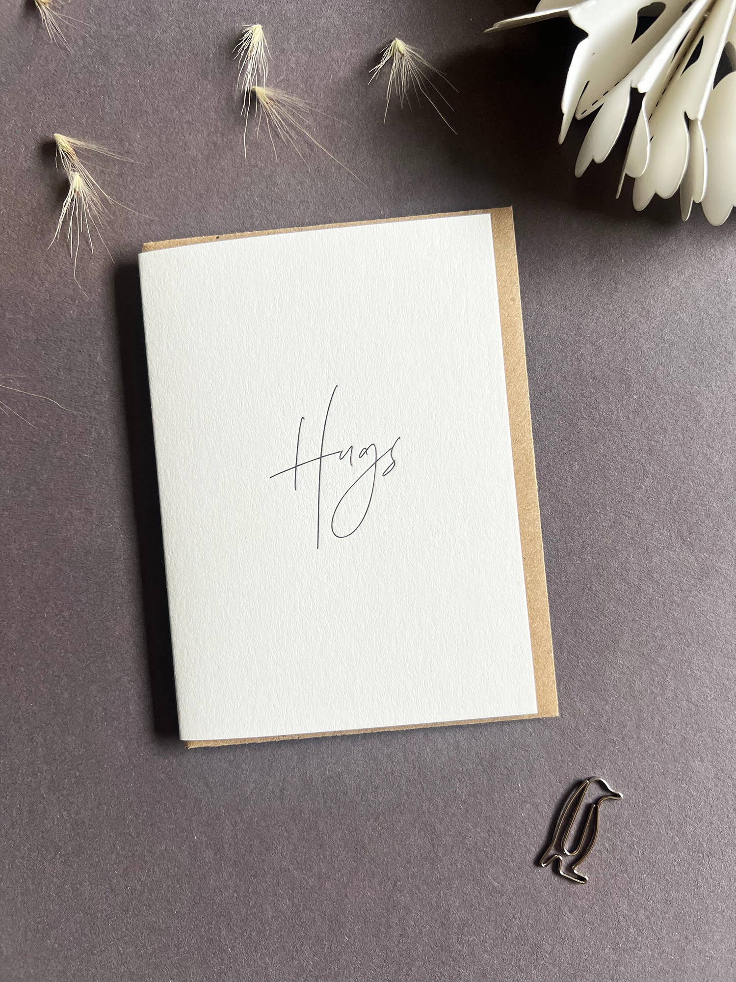 Penguin Ink Hugs letterpress mini thinking of you card with modern calligraphy, printed on 100% recycled board with a tactile embossed finish and C7 envelope.