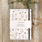 Beautiful A5 lined notebook featuring an elegant bees and honeysuckle design. Perfect for journalling, planning, note-taking and thoughtful gifting.