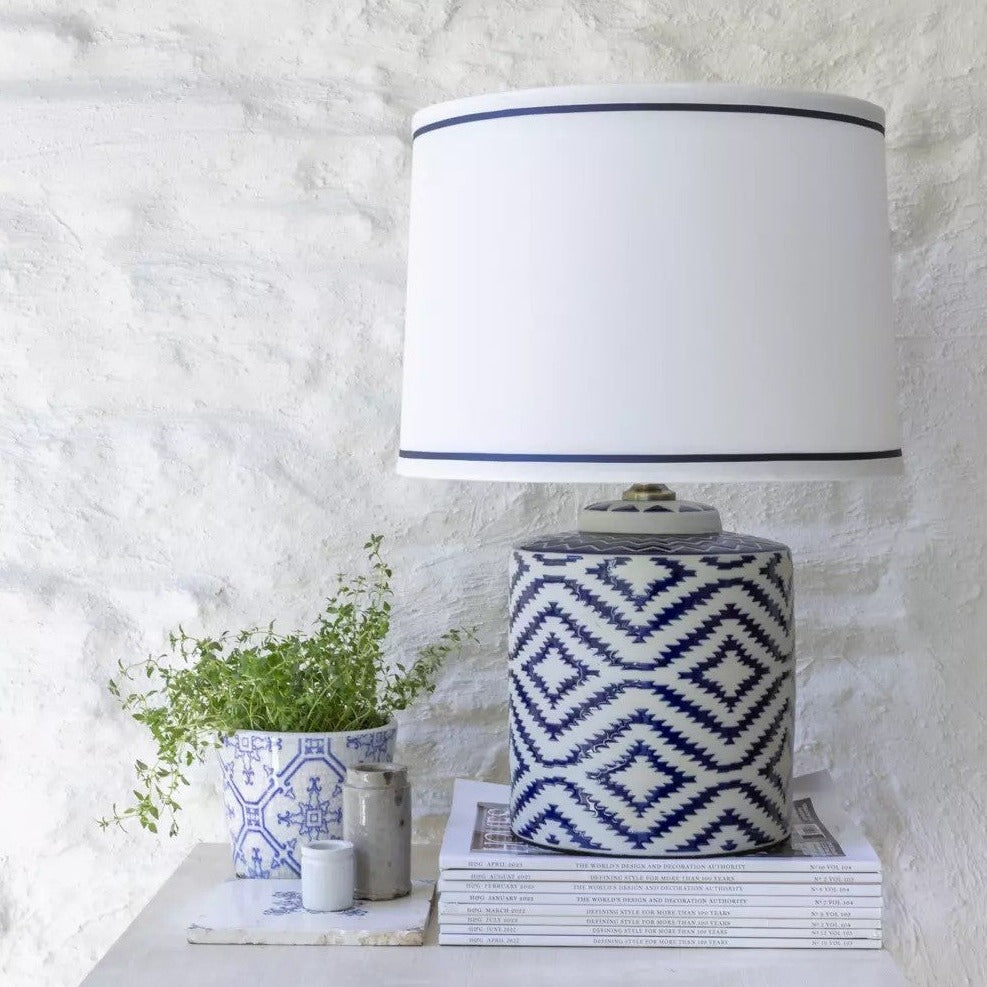 Elegant ceramic table lamp with hand-painted French blue ikat design and crisp white shade. A timeless statement lamp for bedrooms and living spaces.