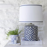 Elegant ceramic table lamp with hand-painted French blue ikat design and crisp white shade. A timeless statement lamp for bedrooms and living spaces.