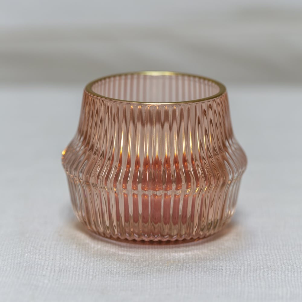 Blush pink ribbed glass votive with a gold rim, adding vintage charm and a warm, romantic glow — perfect for cosy evenings or elegant décor.
