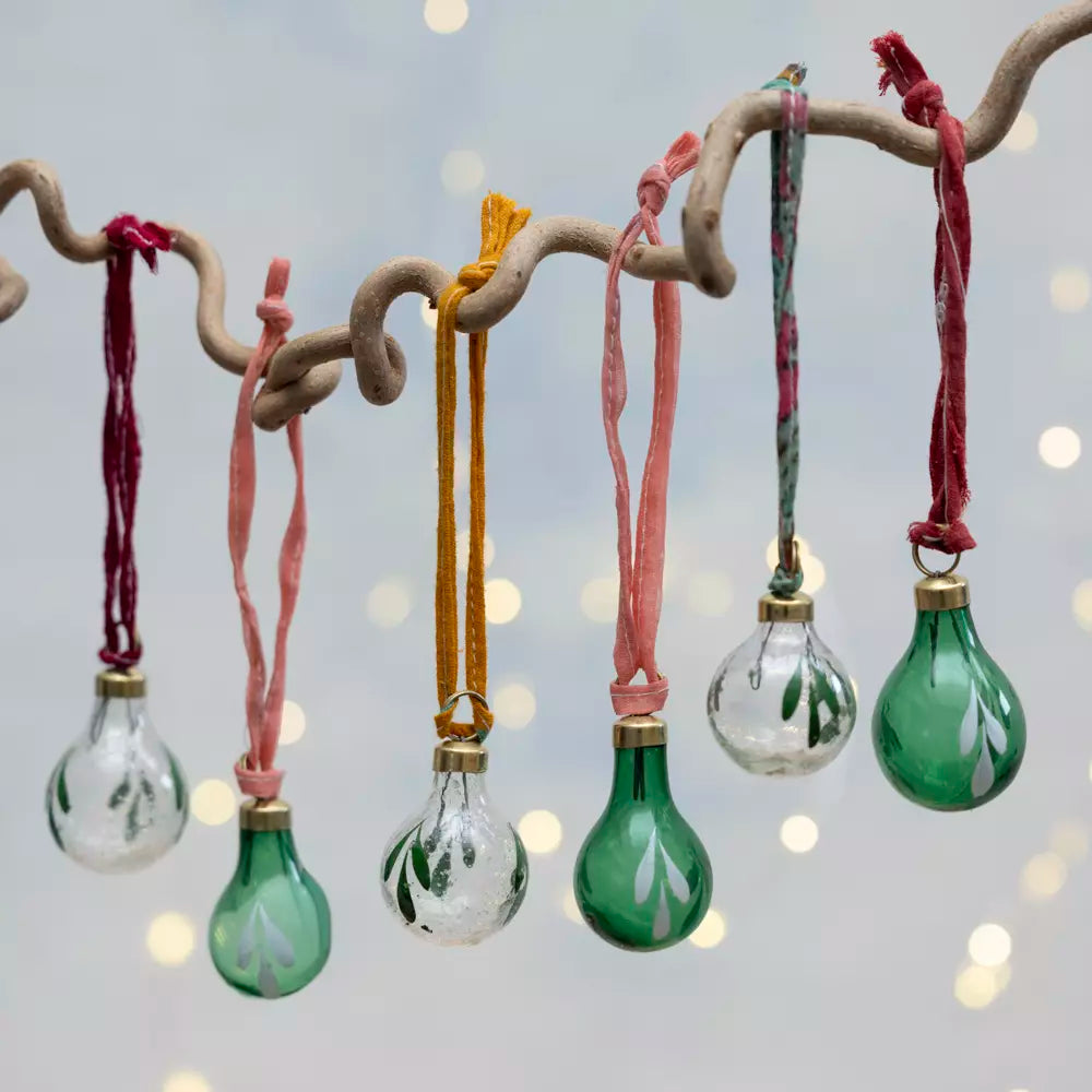 Set of six clear and green glass Christmas baubles with hand-painted botanical leaves